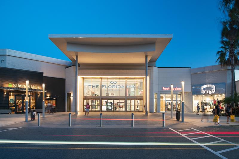 Main entrance at dusk with Shake Shack and Foot Locker — The Florida Mall, Orlando FL