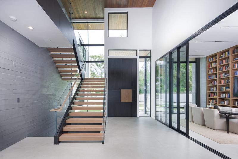Floating staircase and two-story glass entry — The New American Home 2026, Orlando FL