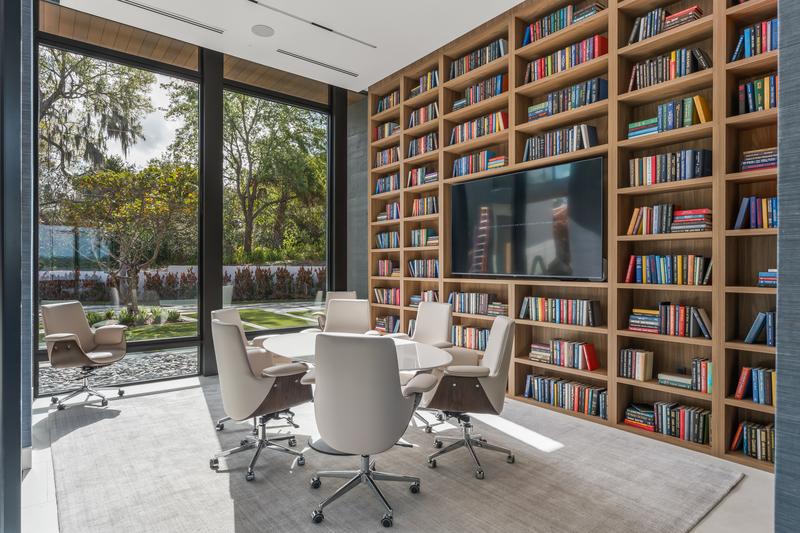 Library with two-story bookshelves and conference table — The New American Home 2026, Orlando FL