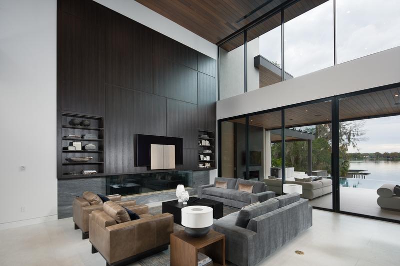 Living room with dark wood feature wall — The New American Home 2026, Orlando FL