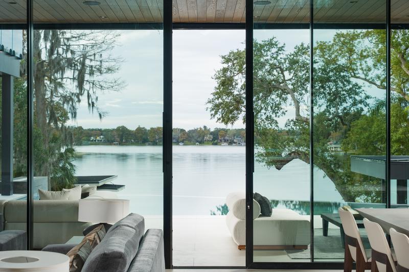 Lakeview lounge with glass walls at dusk — The New American Home 2026, Orlando FL