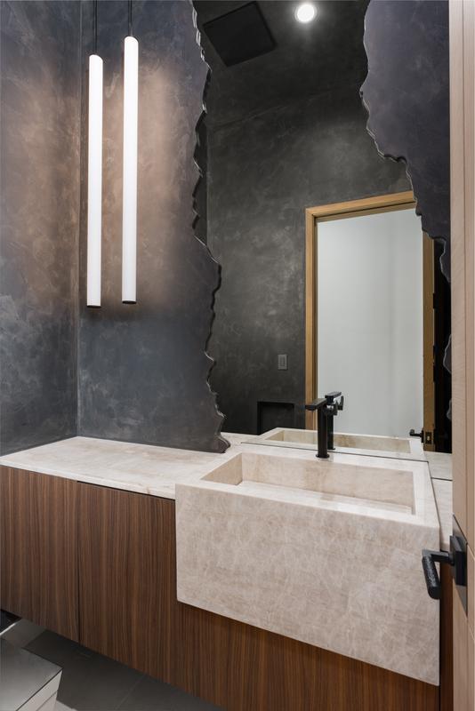 Powder bath with natural stone feature wall — The New American Home 2026, Orlando FL