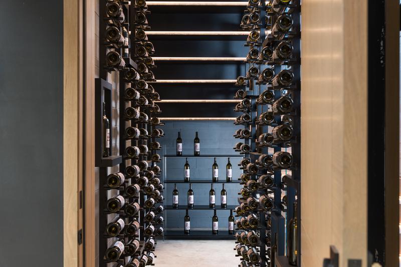 Backlit wine display wall — The New American Home 2026, Orlando FL