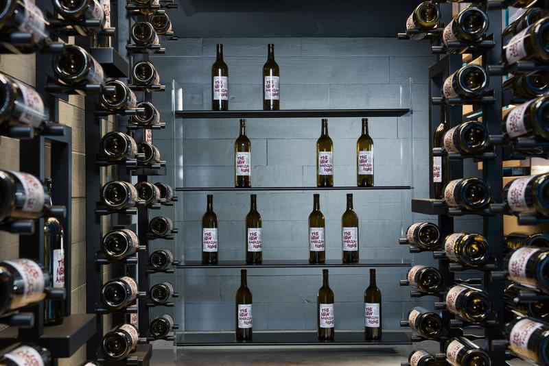 Wine wall detail with floating bottle racks — The New American Home 2026, Orlando FL