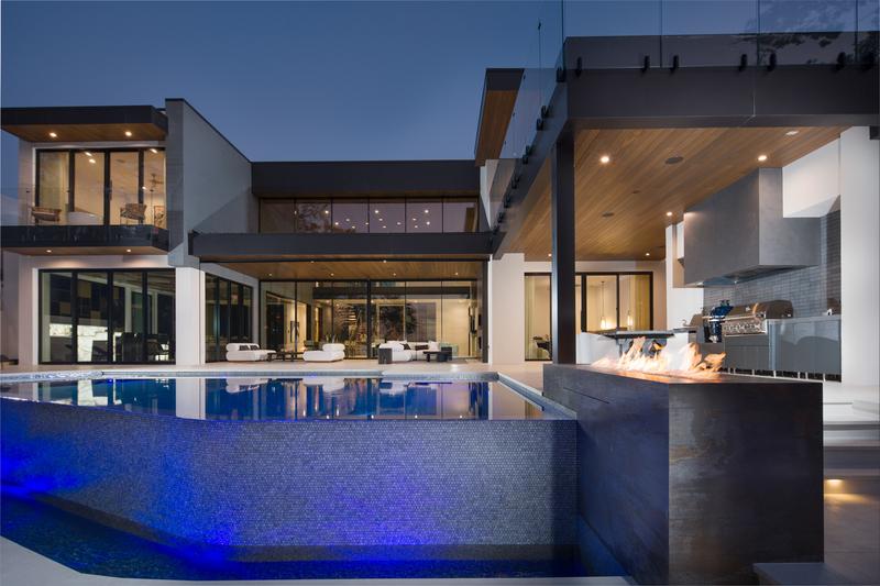 Rear elevation with pool and fire features at dusk — The New American Home 2026, Orlando FL