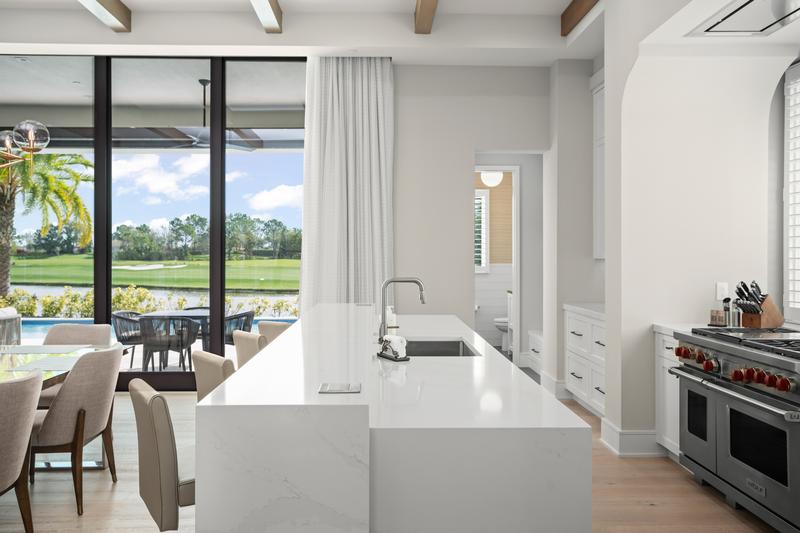 Kitchen with waterfall-edge island facing the lanai — Ritz-Carlton Residences at Grande Lakes, Orlando FL