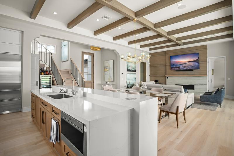 Open kitchen and great room with wood ceiling beams — Ritz-Carlton Residences at Grande Lakes, Orlando FL