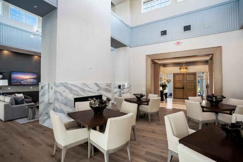 Clubhouse lounge with marble fireplace surround — Ritz-Carlton Residences at Grande Lakes, Orlando FL