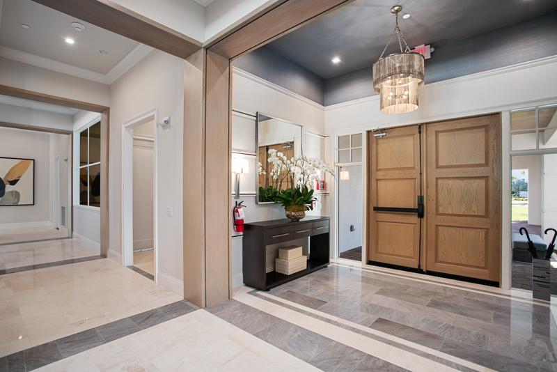Entry foyer with chandelier and wood double doors — Ritz-Carlton Residences at Grande Lakes, Orlando FL