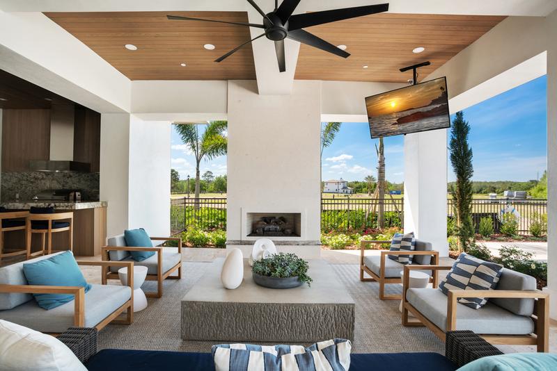 Covered lanai lounge with fireplace and TV — Ritz-Carlton Residences at Grande Lakes, Orlando FL