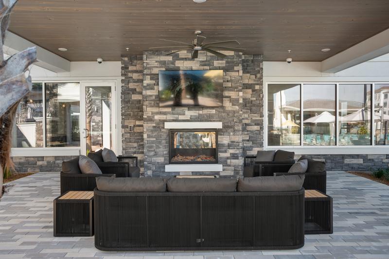 Outdoor lounge with stone fireplace — Sanctuary at Daytona apartments, Daytona Beach FL