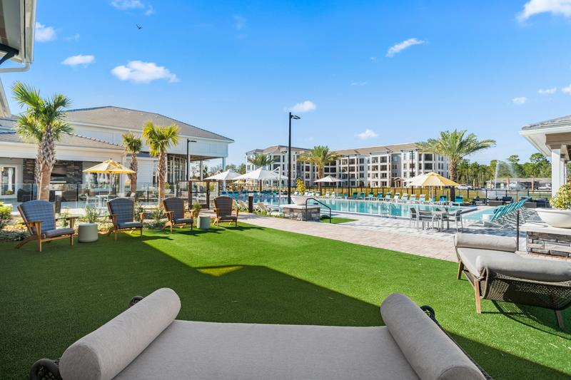 Pool lawn with cabanas and loungers — Sanctuary at Daytona apartments, Daytona Beach FL