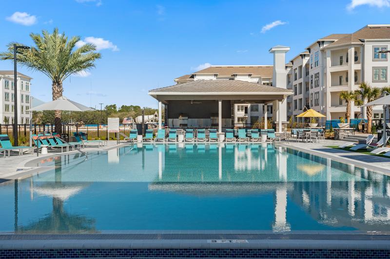 Resort-style pool with palm trees — Sanctuary at Daytona apartments, Daytona Beach FL