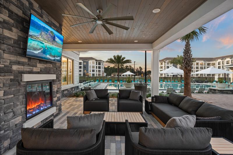 Covered outdoor lounge with fireplace and TV — Sanctuary at Daytona apartments, Daytona Beach FL