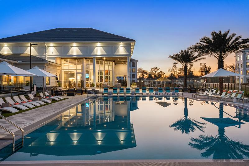 Pool and cabanas at dusk — Sanctuary at Daytona apartments, Daytona Beach FL