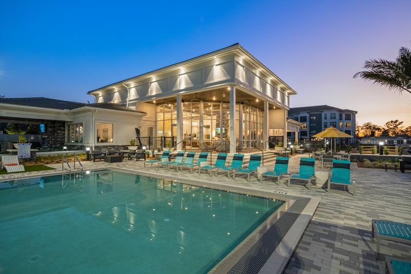 Pool deck and clubhouse at dusk — Sanctuary at Daytona apartments, Daytona Beach FL